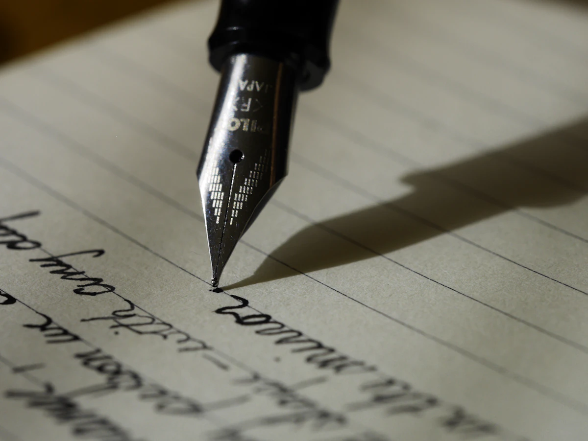 A notebook open to a fresh page with morning coffee and sunlight